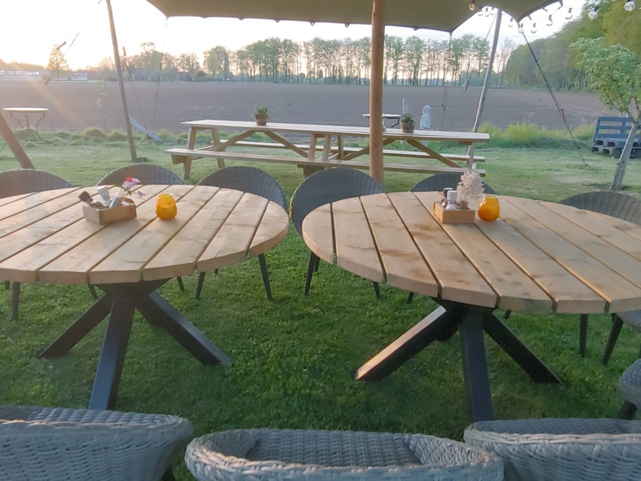 Ronde tuintafel groot tafelblad van hout  met poten van metaalkleur staal zwart 